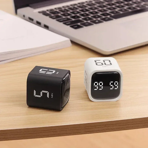 Lockin Cube focus timers in black and white on a desk